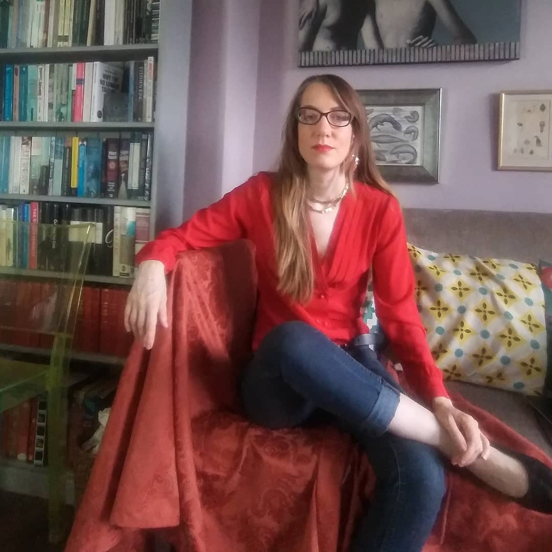 Sophia McDougall sitting on a sofa